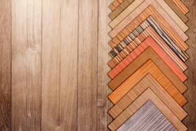 Wooden sample swatches arranged in a vertical stack on a wooden background, Laminate Flooring